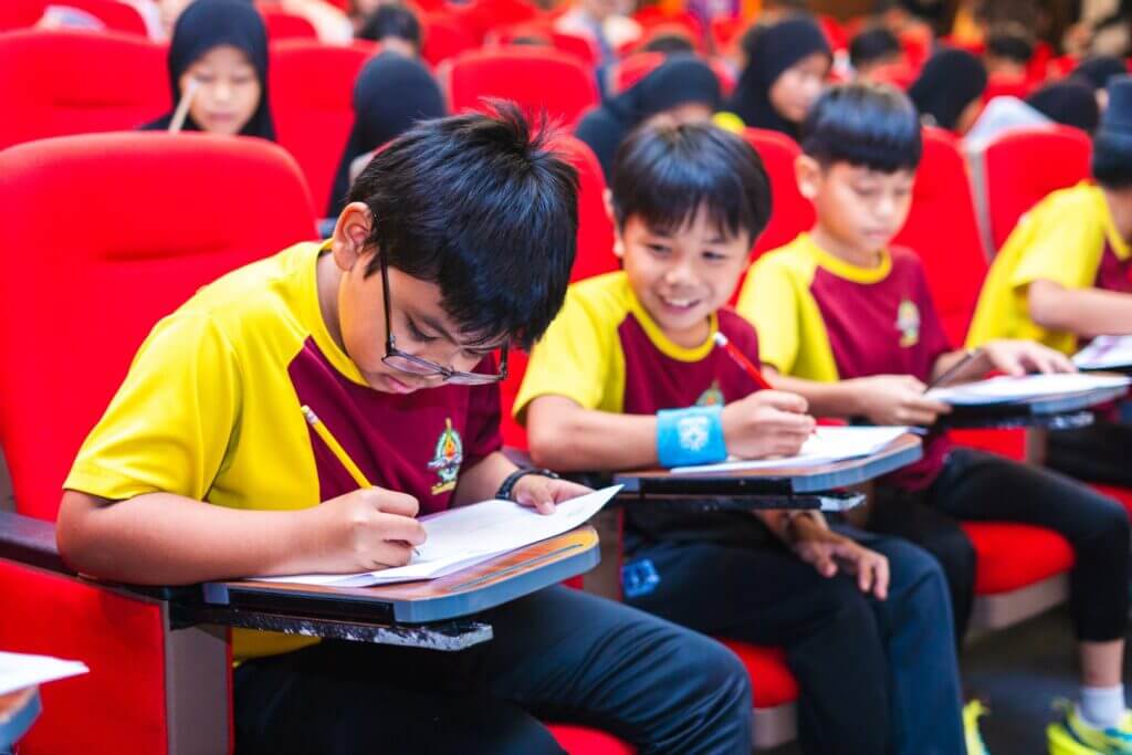 Children taking a test or working in a classroom setting.