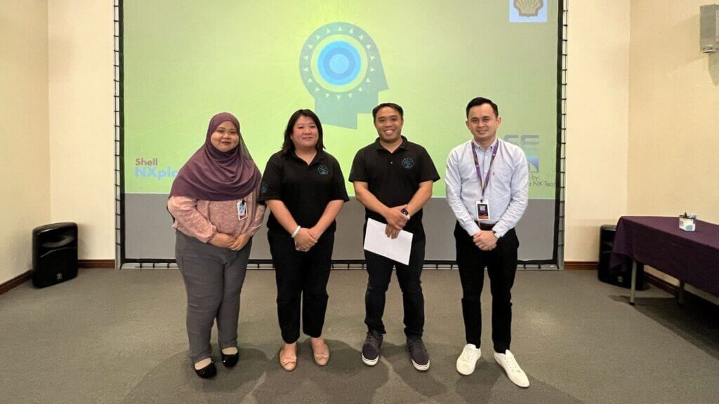 Four people stand in front of a screen for the NXPLORERS RECOGNITION AWARD 2022.